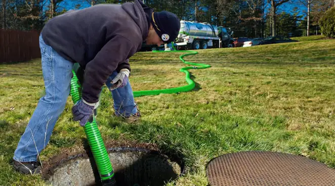 Service technician performing residential septic pumping and drainage maintenance in Detroit, MI